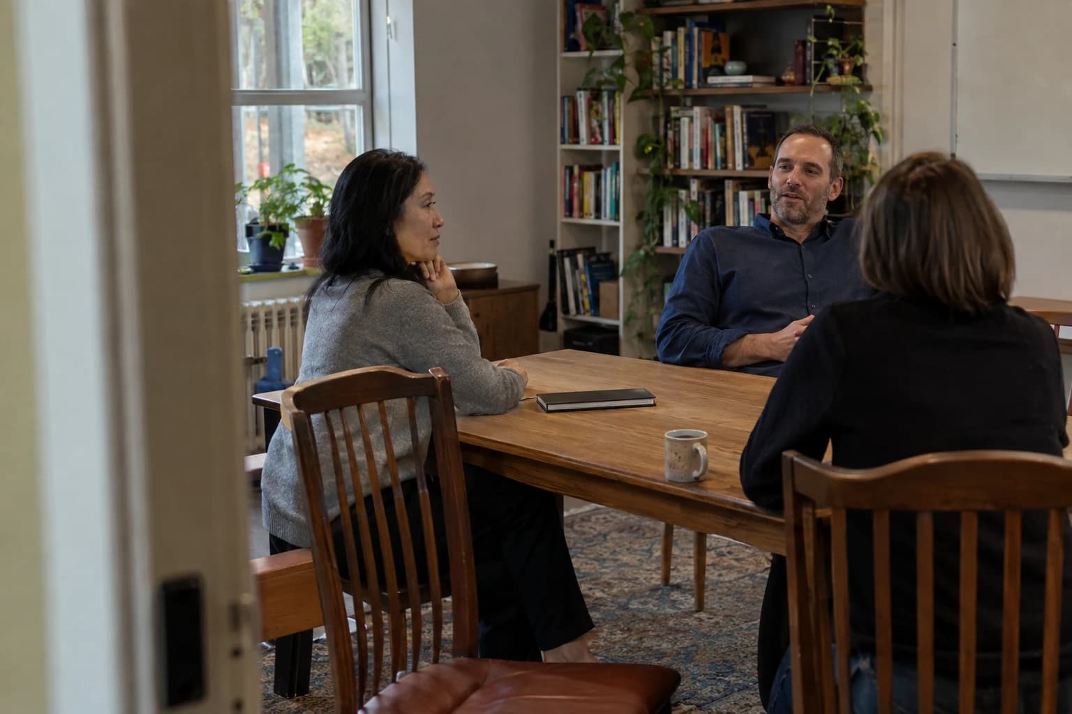 Colleagues in a candid conversation around a table